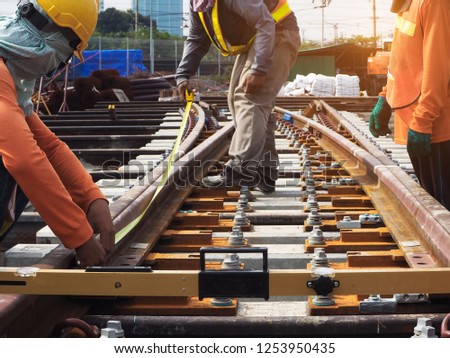 construction workers setting the rail for the evevated train railway Royalty-Free Stock Photo #1253950435