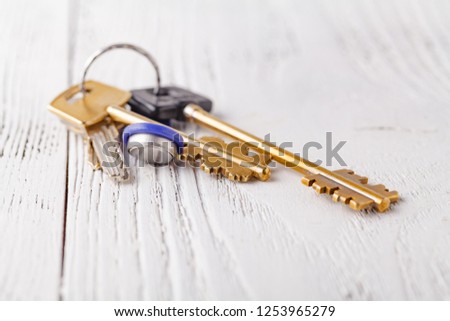 Golden keys to the apartment on wooden background