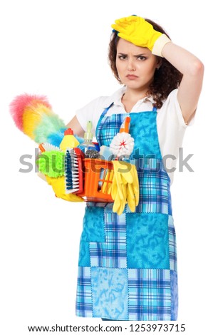 Tired young housewife with yellow gloves and cleaning supplies in box, isolated on white background