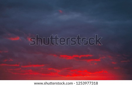 Beautiful bright colorful sky. Picture taken at sunset. Red-orange background with nice paints. Rare sunrise. Natural composition

