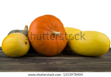 raw pumpkin on wooden table isolated on white background