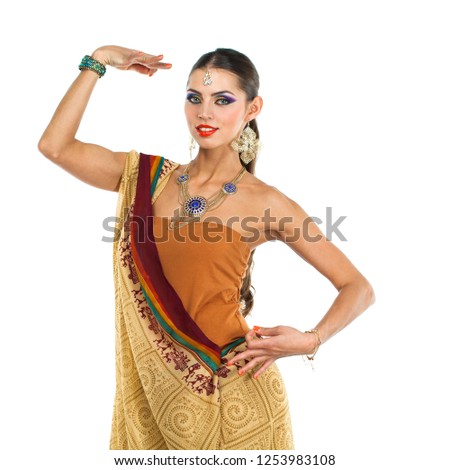 Caucasian brunette woman in brown indian national dress sari in studio on white isolated background 