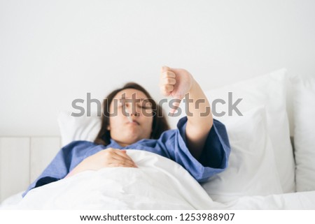 Asian Beautiful Woman Hypothermia has been measured by fever. Lie on the bed to give a body of rehabilitation. The concept of medical care to patients at home by yourself. Royalty-Free Stock Photo #1253988907
