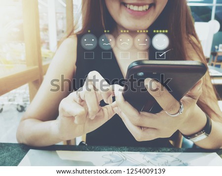 Customer experience concept, happy business women holding the smartphone with a checked box on excellent smiley face and rating for a satisfaction survey. stock photos