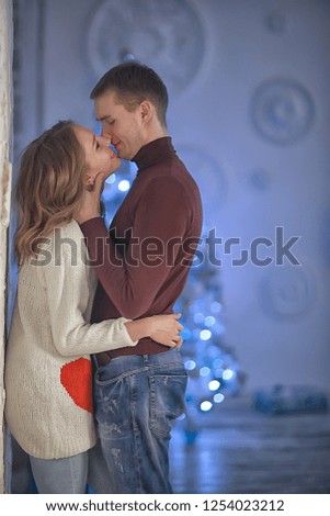 New Year's photo people / young man and girl in the Christmas interior, cozy decorated house
