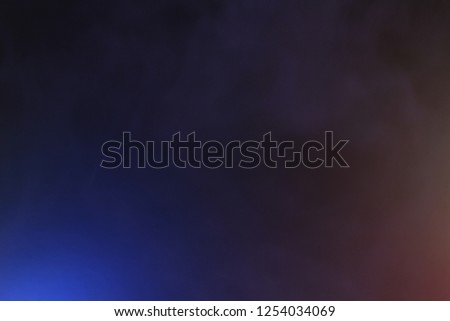 Blue background with steam for design. Gentle light on the surface. Beautiful gradient on a black background with smoke. Raster image.