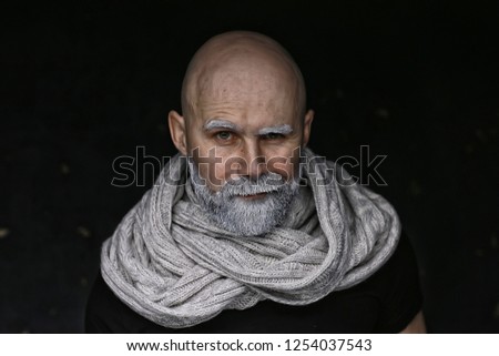 brutal man with a beard in winter clothes / portrait person with a gray beard, hipster warm clothes winter
