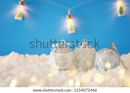 Image of christmas festive tree white ball decoration in front of blue background 