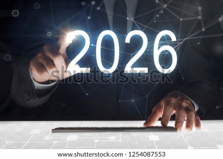 Business man touching screen with 2026 writing