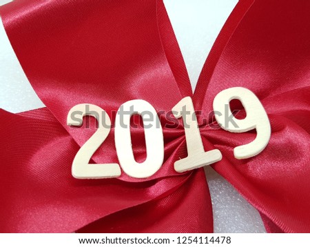 2019 wooden figures over red ribbon on white background.New year concept.
