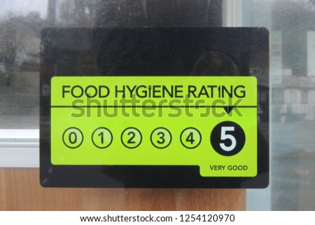 A Food Hygiene Rating sign showing a rating of 5, on a cafe in Polperro, Cornwall