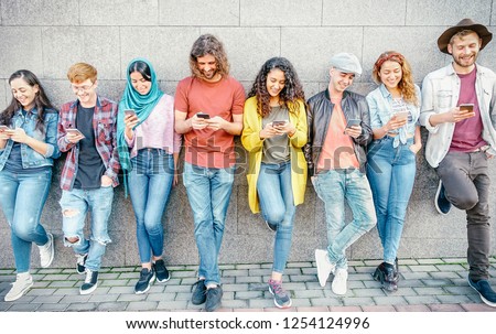 Group of fashion friends watching on their smart mobile phones - Millennial generation z addicted to new technology trends - Concept of people, tech, social media, friendship and youth lifestyle Royalty-Free Stock Photo #1254124996