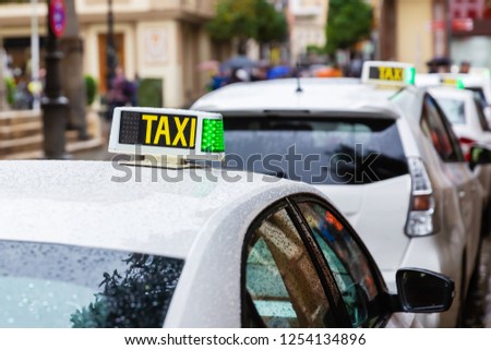 picture of local taxis standing in a row in Seville, Spain