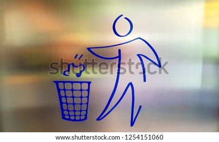 Drawing, blue icon of a person throwing trash, garbage, in a trash can.