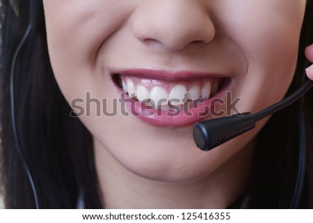 close up of a woman mouth using a phone headset