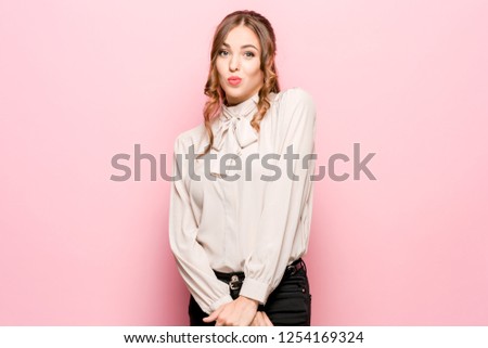 Let me think. Doubt concept. Doubtful pensive woman with thoughtful expression making choice. Young emotional woman. Human emotions, facial expression concept. Studio. Isolated on trendy pink