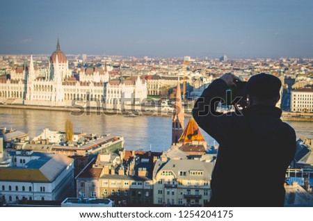 A man takes photo of attractions in Budapest, Hungary 