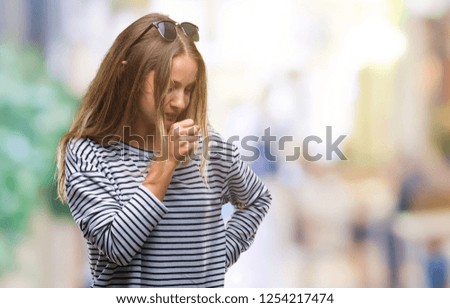 Young beautiful blonde woman wearing sunglasses over isolated background feeling unwell and coughing as symptom for cold or bronchitis. Healthcare concept.