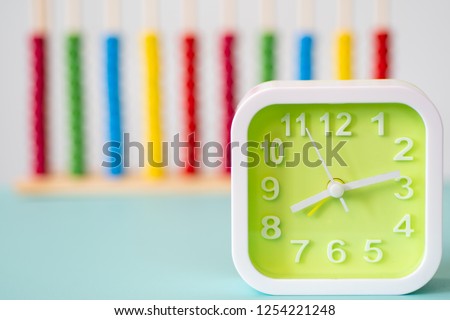 clock on table with colorful background