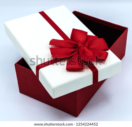 Open the red ribbon gift box. on the white blackground.