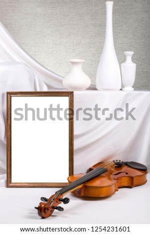 Photo frame for your mock-up on the table with violin and vases