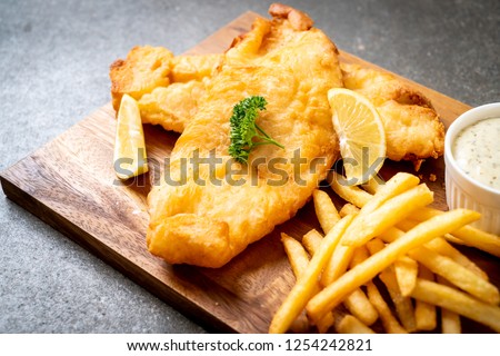 fish and chips with french fries - unhealthy food Royalty-Free Stock Photo #1254242821