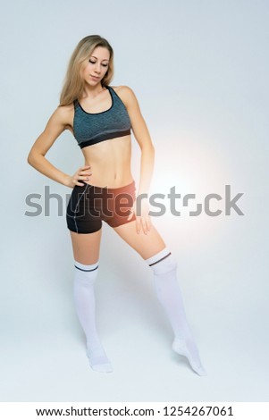 Concept portrait of a beautiful fitness girl blonde smiling on a white background advertisement.