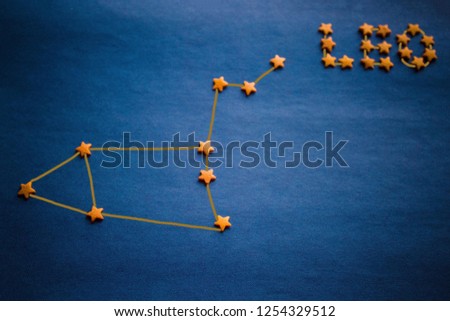 Blue background, yellow decorative stars. The location of the stars in the constellation Leo. Vignetting, copy space. The picture is made by the author.
