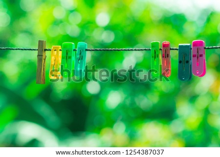 colourful clothes pegs or clothespin with bokeh background