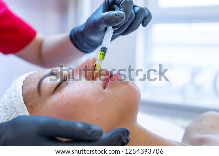 Hardware cosmetology, mesotherapy, portrait of young woman getting treatment of forehead zone. Picture of woman having facial mesotherapy in beauty salon