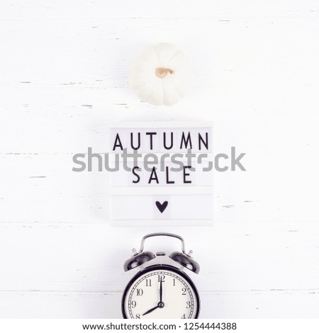 Creative Top view flat lay promotion composition Autumn sale text on lightbox white background copy space Template Autumn sale mockup fall seasonal offer promotion advertising with alarm clock
