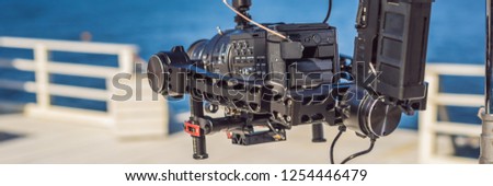 profeccional cinema camera on a 3-axis camera stabilizer system on a commercial production set BANNER, LONG FORMAT