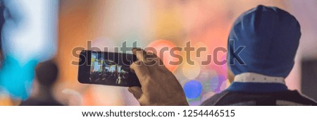 Use advanced mobile recording, fun concerts and beautiful lighting, Candid image of crowd at rock concert, Close up of recording video with smartphone, Enjoy the use of mobile photography BANNER, LONG