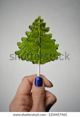 candy lollipop christmas tree in hand white isolated