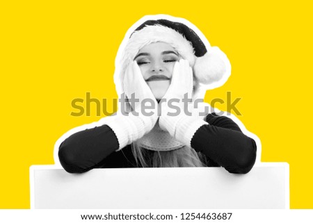 Attractive smiling young girl dressed in Santa's hat holds flipchart board and dreams about gifts. Christmas and New Year advertising concept. Magazine style fashion collage with blank copy space