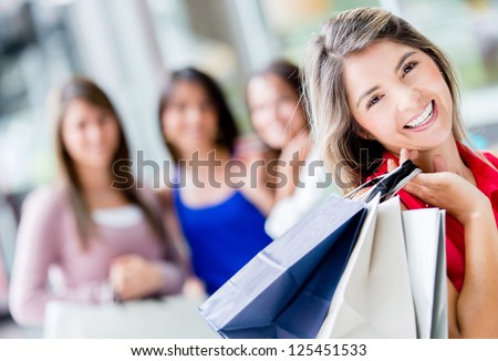 Happy shopping woman with a group of friends