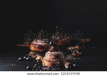 Traditional sweet homemade cinnamon rolls. Freshly baked cinnamon rolls buns with cocoa on wooden background . Top view . Space for text. Sweet Homemade christmas baking. Cinnamon rolls buns with coco