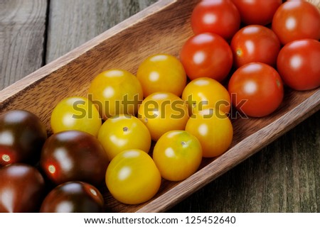 fresh tomatoes on long wooden plate