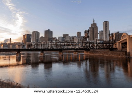 A Wide Angle Shot of the St. Paul Skyline and Bridges Reflecting in the Mississippi River during a Winter Sunset