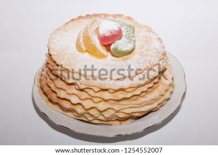 Stack of waffles on a plate. Waffles with colored marmalade. Waffles on white background.