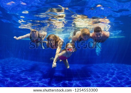 Happy family in swimming pool. Smiling mother, children and grandparents swim, dive in pool with fun - jump deep down underwater. Healthy lifestyle, people water sport activity on holidays with kids Royalty-Free Stock Photo #1254553300