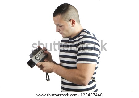 young man recording with old movie camera domestic