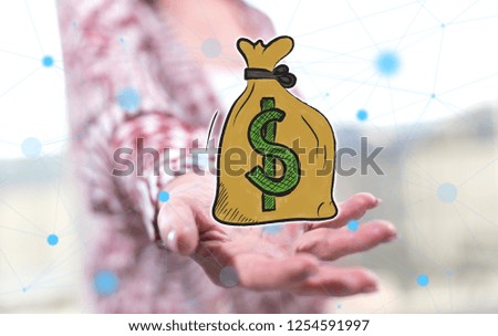 Money concept above the hand of a woman in background