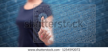 Woman touching a labyrinth concept on a touch screen with her finger