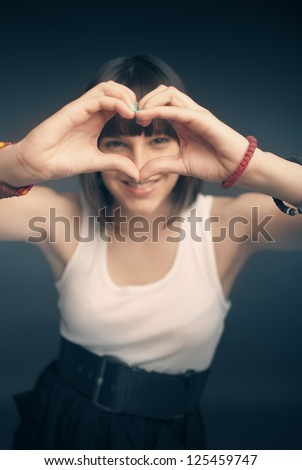 Picture of beautiful girl forming heart shape