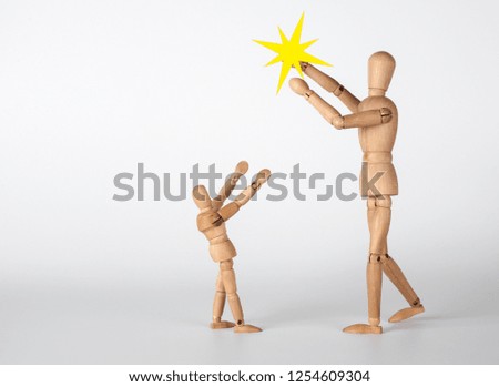 Christmas story. Two little wooden men with the shining star of 