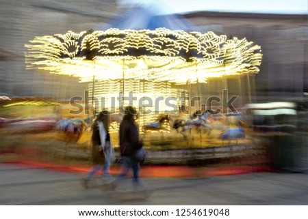 Children's carousel, illuminated, Christmas parties, homage to Monet, photographic sweeps at low shutter speed, impressionism, sensation of movement, unrecognizable silhouettes, Toledo, Spain,