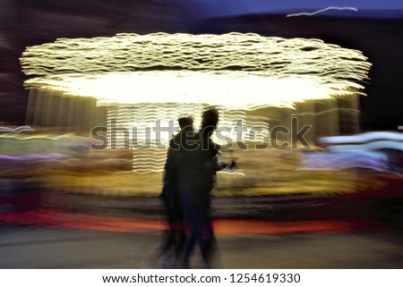 Children's carousel, illuminated, Christmas parties, homage to Monet, tribute to Ernst Hass, photographic sweeps at low shutter speed, impressionism, sensation of movement, Toledo, Spain,
