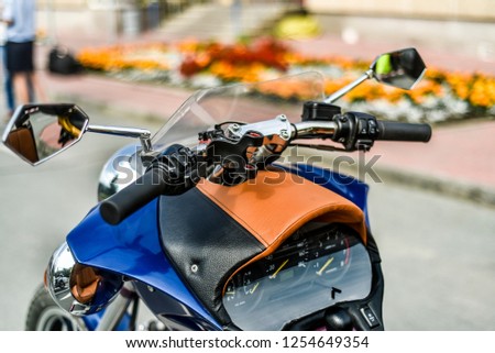 Motorcycles on the background of the city. Beautiful and stylish control panel and the front of the modern motorcycle at close range against the background of the city.