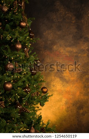 Christmas Tree decorated with Brown and golden decorations against a dark background